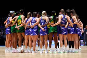 Players of Team Jamaica and Team Scotland huddle after the Preliminary Round Pool 