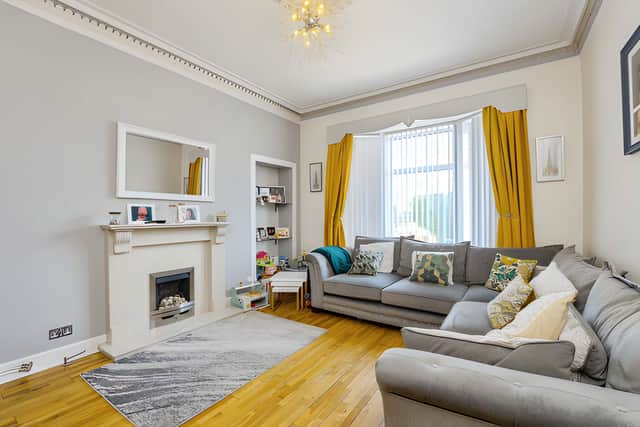 The formal lounge provides a dedicated reception space alongside the home's separate dining kitchen