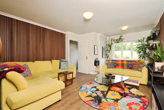 The bright lounge forms part of a flexible ground-floor layout with a separate dining area and second seating room