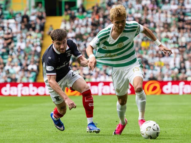 Falkirk full-back Ryan Strain chases down Celtic winger Hyun-jun Yang