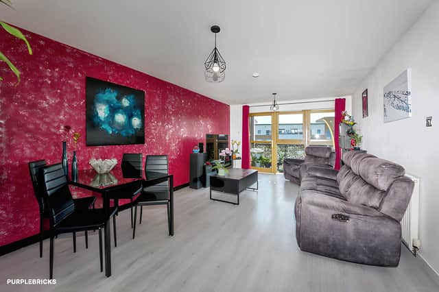 South-facing floor-to-ceiling windows bring natural light into the apartment's generous main living area