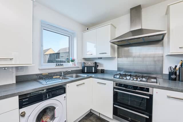 The modern kitchen/diner forms a central part of the home's family-friendly layout