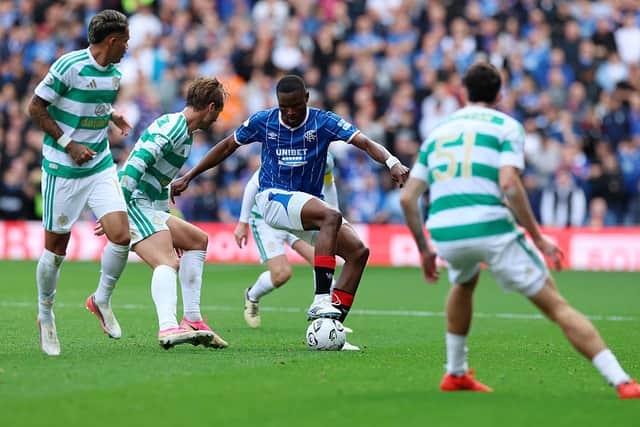 Olwethu Makhanya of Rangers in possession of the ball under pressure from Benjamin Nygren of Celtic