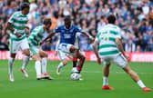 Olwethu Makhanya of Rangers in possession of the ball under pressure from Benjamin Nygren of Celtic