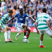 Olwethu Makhanya of Rangers in possession of the ball under pressure from Benjamin Nygren of Celtic