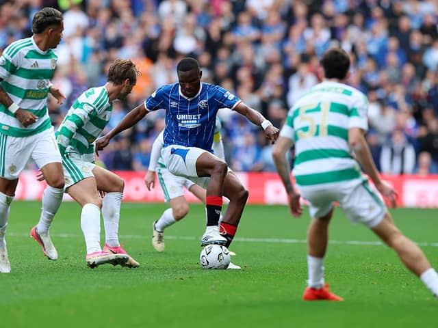 Olwethu Makhanya of Rangers in possession of the ball under pressure from Benjamin Nygren of Celtic