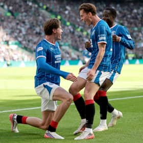 Ryan Naderi of Rangers celebrates scoring his team's first goal with team mates James Penrice and Djeidi Gassama 