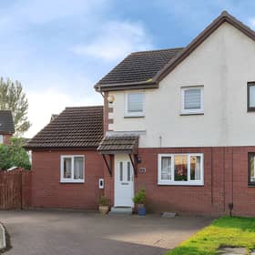 The modern semi-detached home has a paved driveway providing ample off-street parking at the front