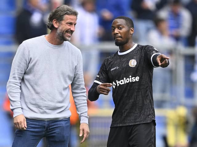 Gent's head coach Rik De Mil (L) speaks with winger Michel-Ange Balikwisha