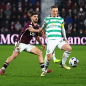 Claudio Braga of Hearts and Callum McGregor of Celtic tussle for possession during a Premiership clash in January 2026