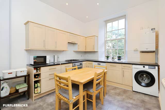 The contemporary dining kitchen combines practical cooking space with room to sit down for meals, adding flexibility to the flat's layout.