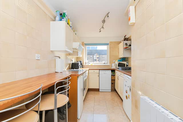 The fitted kitchen sits just off the lounge, creating a practical arrangement for preparing meals while keeping the main living space separate.