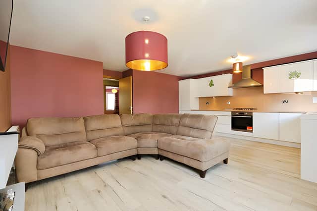 The open-plan lounge and kitchen bring relaxing, dining and cooking together, with a door from the kitchen leading to a Parisian-style balcony