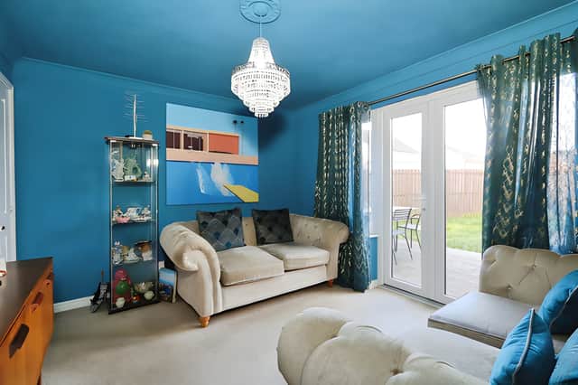 French doors connect the rear lounge to the enclosed garden, bringing the outdoor space into the heart of the home