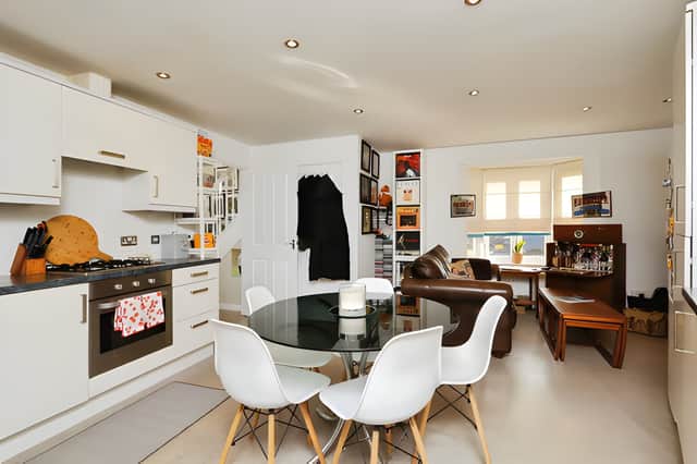 The modern fitted kitchen has space for dining and a separate seating area, giving the household room for everyday meals and informal gatherings