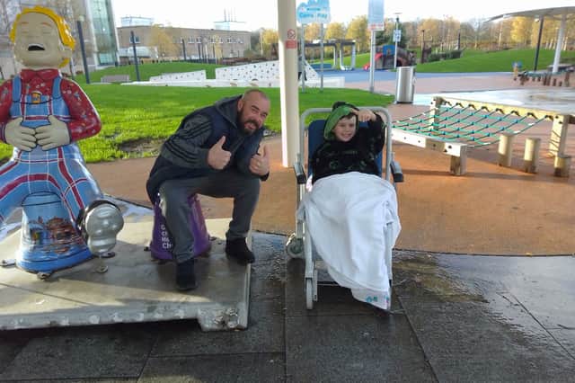 Riley and his dad Scott Luke outside the hospital in Glasgow