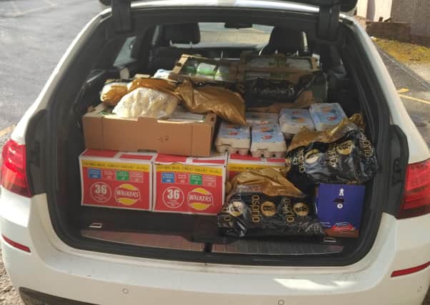 All loaded up and ready to go ... a boot full of goods for the club's food delivery service.