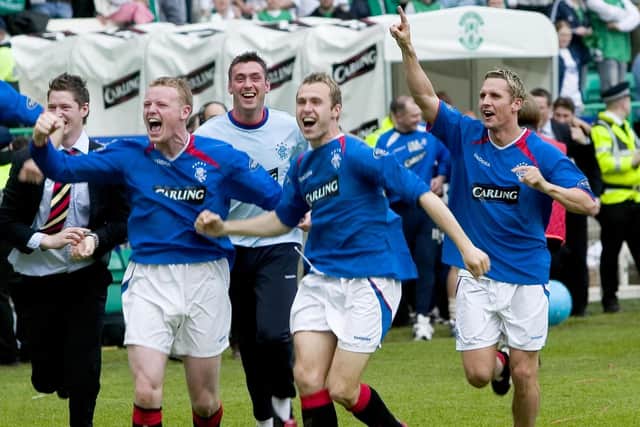 Michael Ball, left, celebrates with his team-mates after Rangers won the title at Easter Road on 'Helicopter Sunday' in 2005. Picture: Bill Murray/SNS