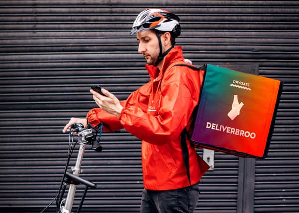 Bicycle delivery man with road bicycle in the city checking delivery address on mobile app
