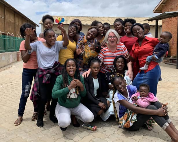 Building a better future...most of the young mums are still children themselves so the Guild members, including Karen Gillon pictured here with the girls, enjoyed seeing them relax and have some fun too.