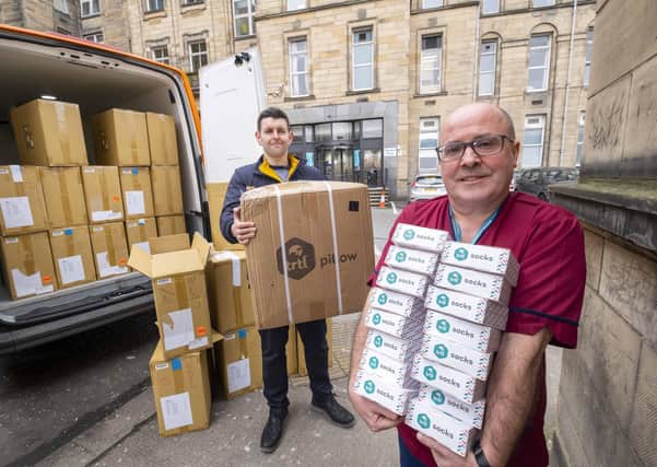 Trtl CEO Michael Corrigan and Glasgow Royal Infirmary chief nurse John Stuart with nurses taking delivery of the socks.
Pic Peter Devlin