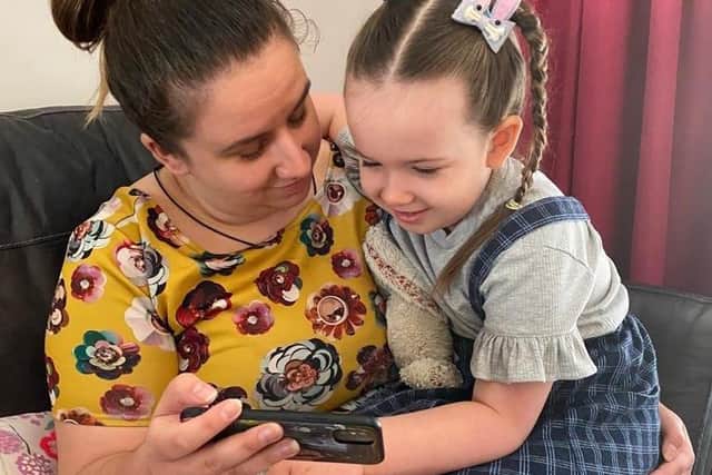 Mum Roz and big sister Millie catch up on baby Lucy's progress by video link.