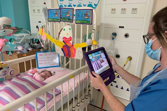 Staff create a video of baby Lucy McAllister for her family to watch.