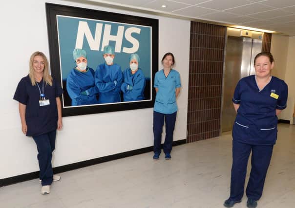 Featuring in the painting are, from left, anaesthetist Dr Kathryn Puxty, physiotherapist Helen Devine and senior charge nurse Suzi Madden.