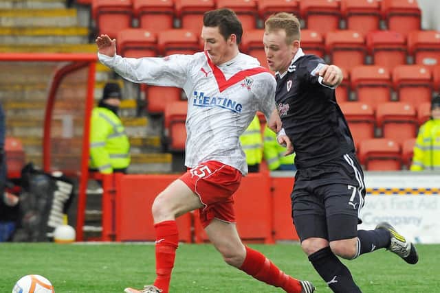 The defender (left) is pictured playing for Airdrie in 2013 (Pic by Michael Gillen)