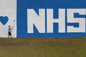 Teacher Thomas Leahy exercises in front ofAbercorn Secondary School's new mural - a tribute to the NHS paintd by PE teacher, David Baird and artist, James Klinge. Photo: John Devlin