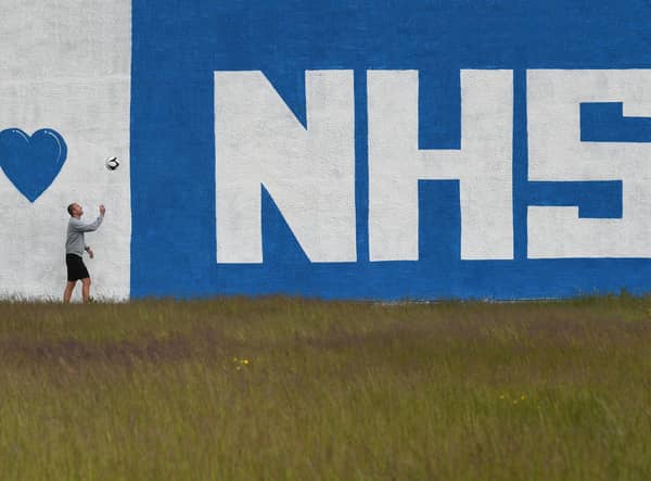 Teacher Thomas Leahy exercises in front ofAbercorn Secondary School's new mural - a tribute to the NHS paintd by PE teacher, David Baird and artist, James Klinge. Photo: John Devlin