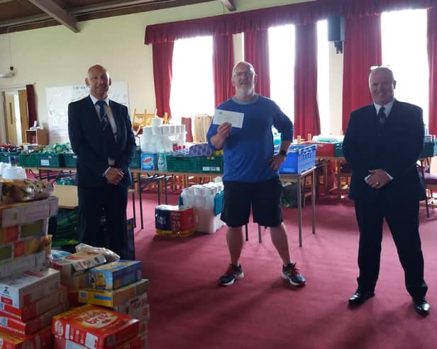 David Dempster (left), of Lodge Newton Mearns, and Stephen Hardy, of Lodge Nitshill, presented the donation to Pastor David Murray.