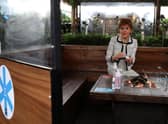 First Minister Nicola Sturgeon sits by a fire pit table during a visit to Cold Town House in Edinburgh's Grassmarket, where she saw the changes in place to keep staff and customers safe in the outdoor hospitality industry. Photo by Andrew Milligan - Pool/Getty Images