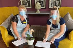 Newton House homemakers Catherine Armstrong (left) and Kara Currie signing the 'Hero Promise'.