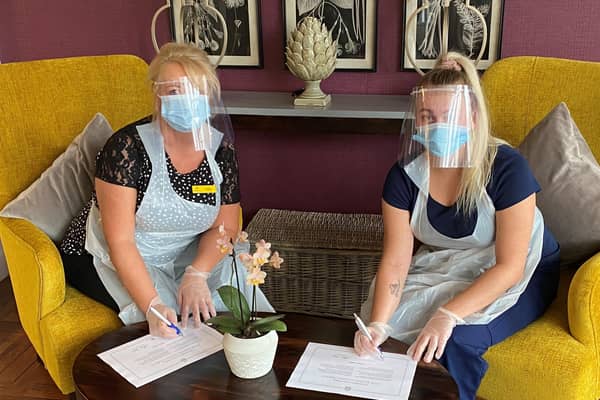 Newton House homemakers Catherine Armstrong (left) and Kara Currie signing the 'Hero Promise'.
