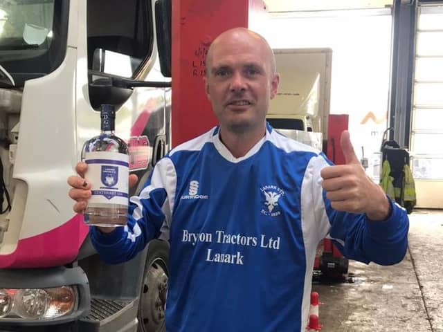 Yowesmad 100 club member Stevie Rydings looks delighted after buying a centenary Lanark United strip and bottle of gin (Submitted pic)