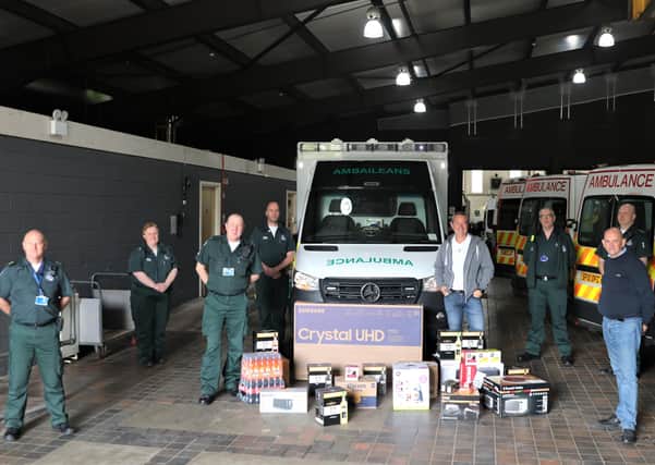 Excelsior Gardens residents Robert Park and Richard Isherwood presenting gifts at Motherwell Ambulance Station