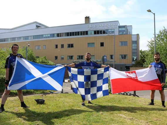 Dalziel aces (from left) holding flags are Brian Thompson, Andy McLaren and club captain Ross Mitchell.