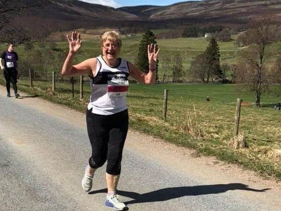 Margaret Allan celebrates finishing one of her 184 park runs, in Shetland last summer.