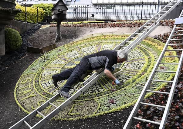 Work takes place earlier this year on the famous Princes Street floral clock in Edinburgh, which for its theme in 2020 thanks NHS staff and keyworkers. Photo: Lisa Ferguson
