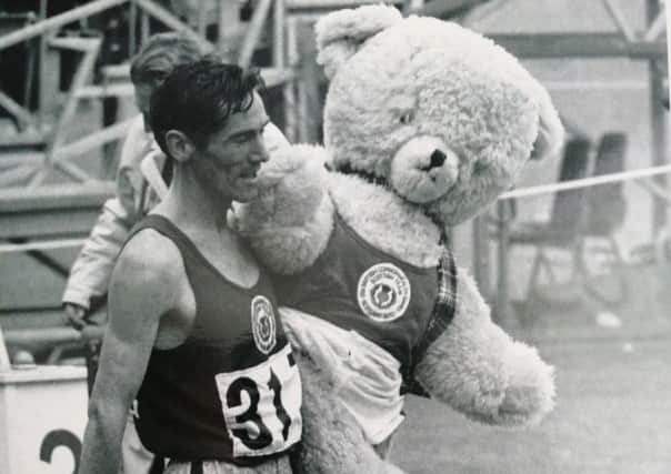 Golden glory...Lachie’s lap of honur with the team mascot, Dunky Dick, named after the coach Frank Dick and sports journalist Dunky Wright.