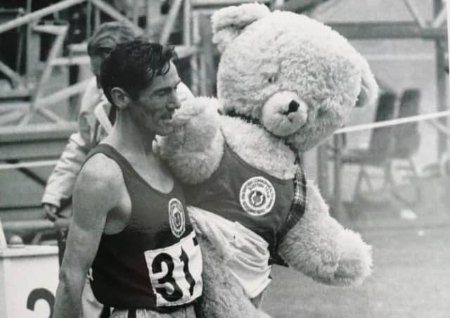 Golden glory...Lachie’s lap of honur with the team mascot, Dunky Dick, named after the coach Frank Dick and sports journalist Dunky Wright.