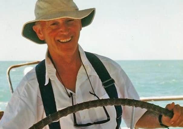 Ian Macpherson at the helm of the yacht John Laing in the Gulf of Carpentaria, Australia