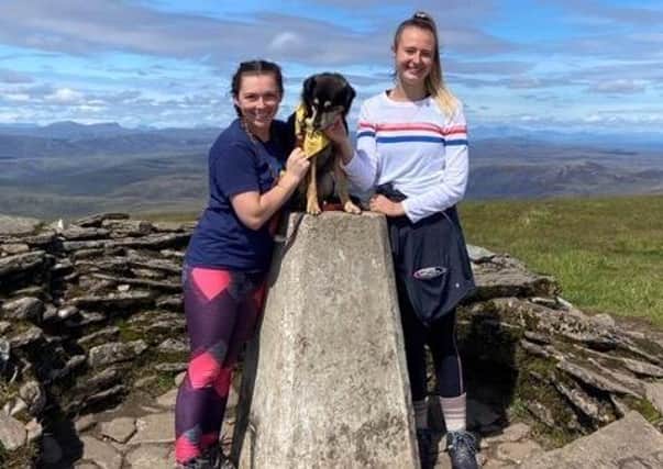 Sophia Baverstock and Emily Shaw from Balfron celebrate with Sherlock as he bags his first Munro on the summit of Ben Wyvis