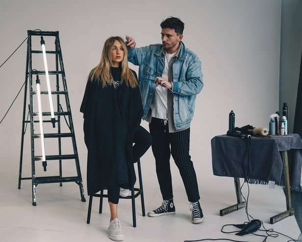 Jack Baxter works on a model while filming with Redken
