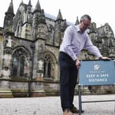 Ian Gardner, director at Rosslyn Chapel Trust, makes the finishing touches ahead of the world-famous church reopening to visitors. Photo: Lisa Ferguson