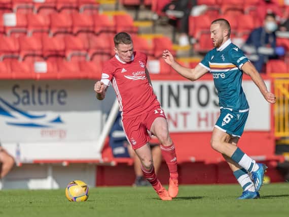 Allan Campbell (right) jostles with Aberdeen star Jonny Hayes at Pittodrie on Sunday (Pic by David Cowe)