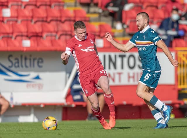 Allan Campbell (right) jostles with Aberdeen star Jonny Hayes at Pittodrie on Sunday (Pic by David Cowe)