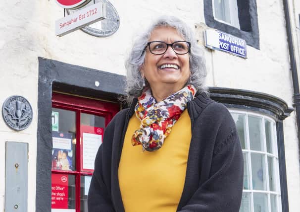 Nazra Alam outside Sanquhar Post Office, which opened its doors in 1712. Pic: SWNS