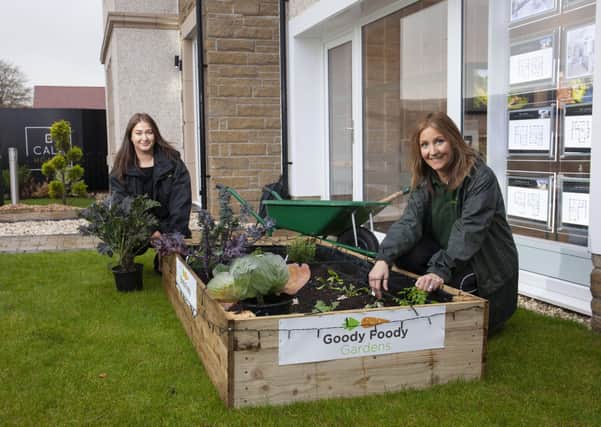 Laura Molloy, Founder of Goody Foody Gardens, and Lisa Curtis, Sales Advisor at CALA Homes (West) at one of the newly installed showhome garden veg patches.